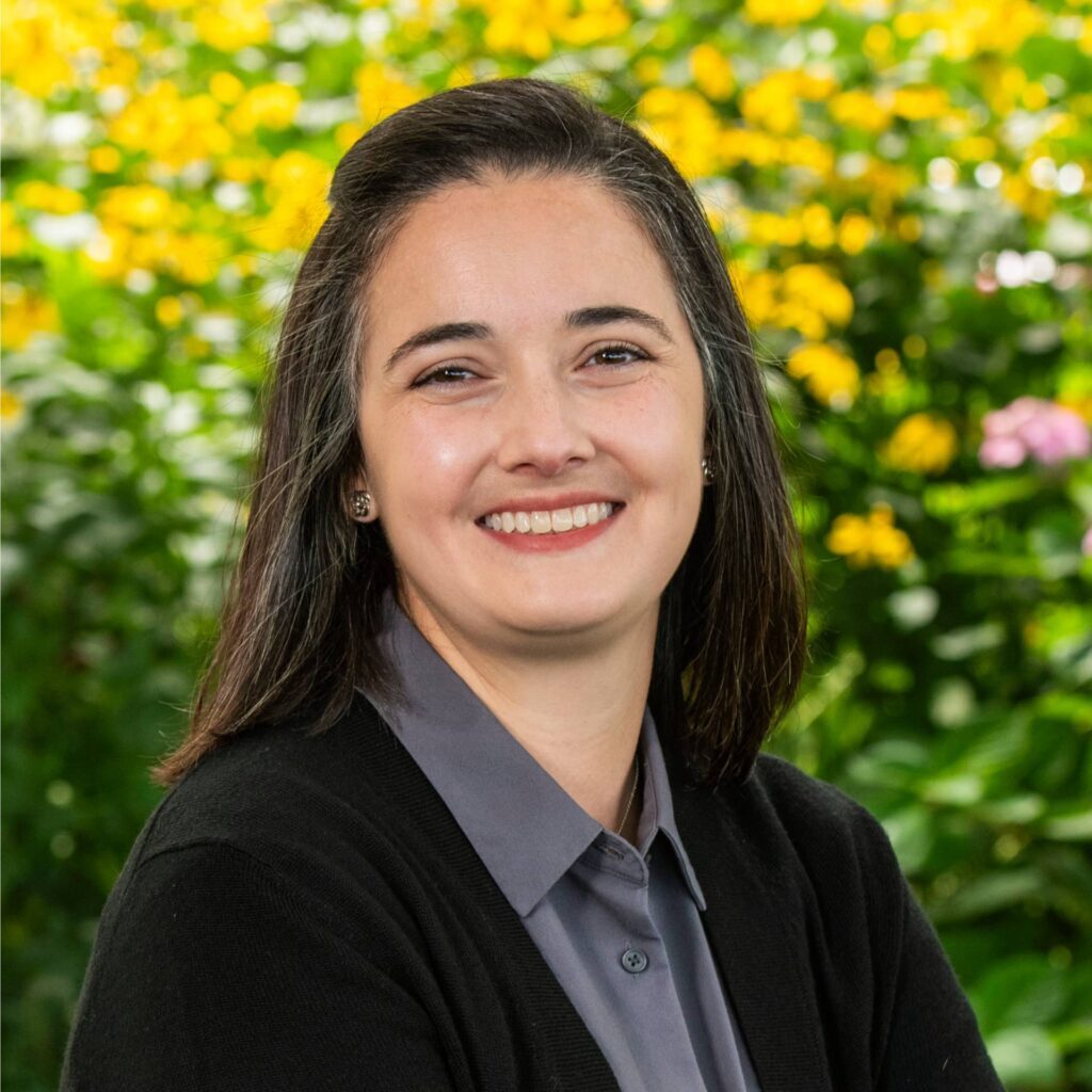 Portrait of Kelli Scott, PhD with floral background.